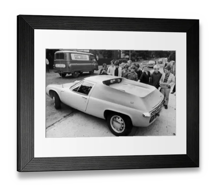 Framed Print : Manchester United footballer George Best surrounded by young fans as he drives away in