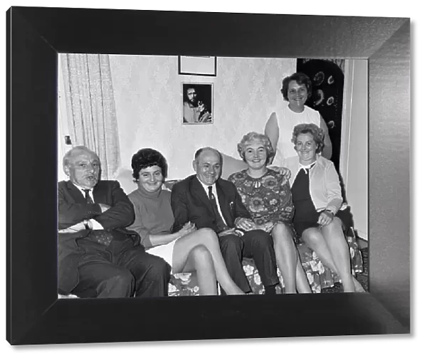 Richard Burtons family at home with a picture of him