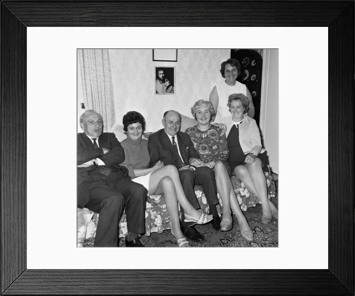 Framed Print : Richard Burtons family at home with a picture of him Framed Print : Richard Burtons family at home with a picture of him