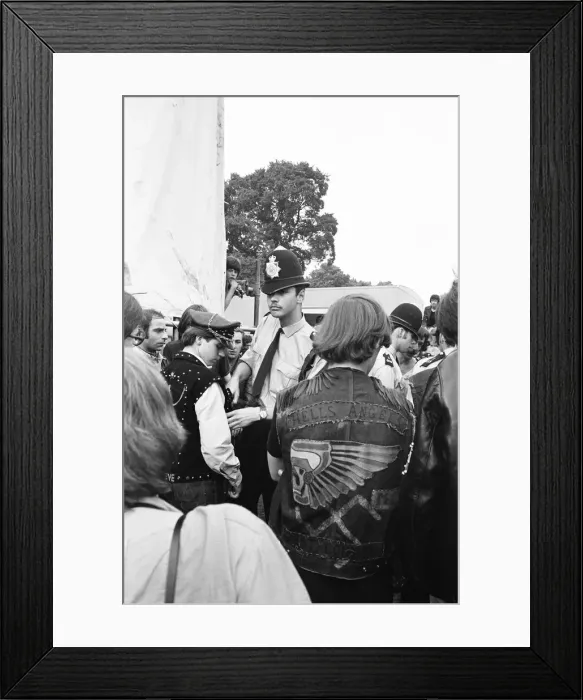 Framed Print : Police search the pockets of Hells Angels during the free Rolling Stones concert in Hyde