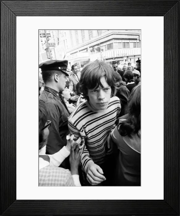 Framed Print : Mick Jagger of The Rolling Stones surrounded by fans on Broadway. 2nd June 1964