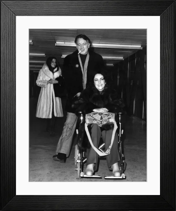Framed Print : Elizabeth Taylor and Richard Burton Pictured at Heathrow Airport. December 1975 Framed Print : Elizabeth Taylor and Richard Burton Pictured at Heathrow Airport. December 1975