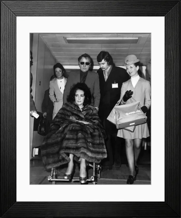 Framed Print : Liz Taylor and Richard Burton at Heathrow Airport today. December 1973
