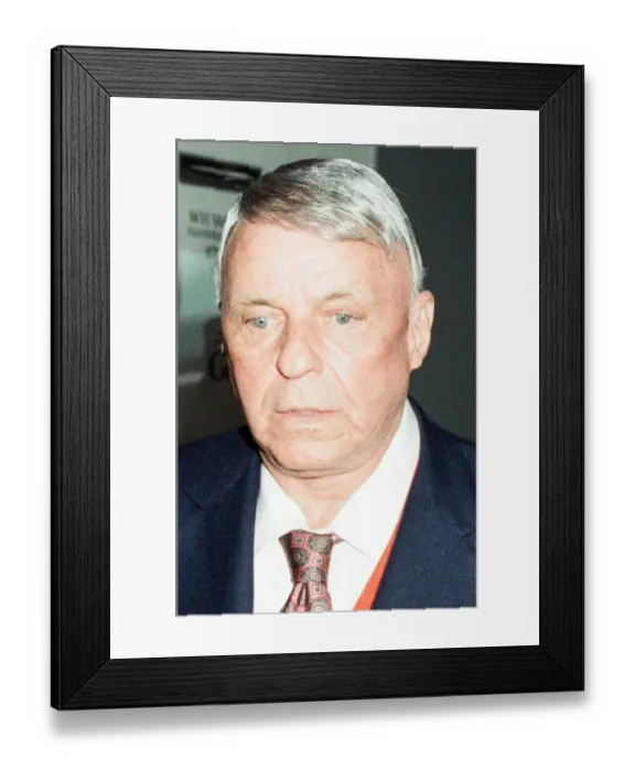 Framed Print : A glum looking Frank Sinatra seen here arriving at Heathrow Airport at the start of his