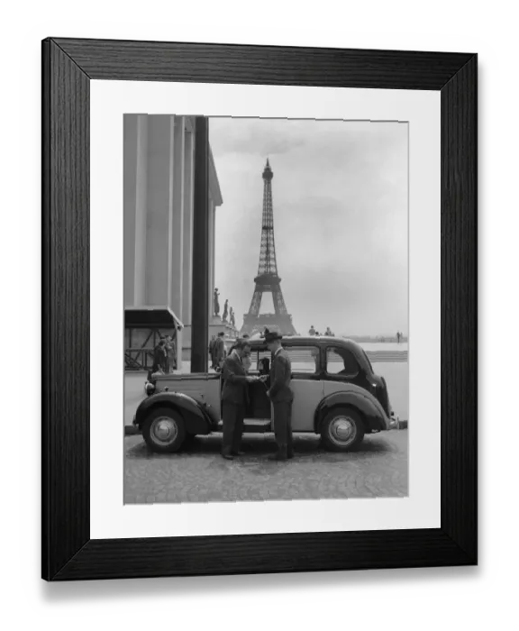 Framed Print : Passenger pays his fare at the end of his journey by the London to Paris taxi service Framed Print : Passenger pays his fare at the end of his journey by the London to Paris taxi service