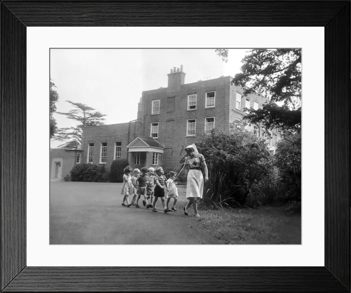 Framed Print : A nurse takes some children for a walk around the grounds of the Beech Hill Convalescent