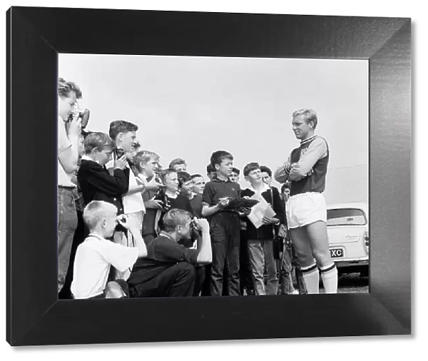 Bobby Moore West Ham United Defender, poses for young fans during a training session open