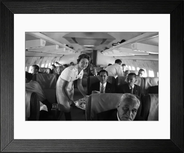 Framed Print : An air stewardess serving food to passengers on board a Qantas Boeing 707 plane at London Framed Print : An air stewardess serving food to passengers on board a Qantas Boeing 707 plane at London