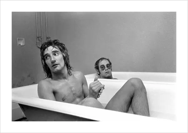 Singers Elton John and Rod Stewart having bath at Watford football ground