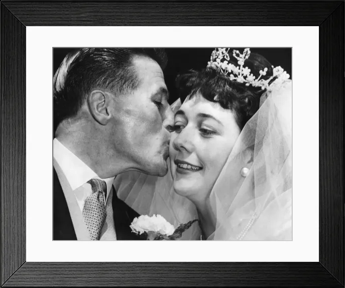 Framed Print : Johnny Dixon, Aston Villas long-service player, kisses his bride, Miss Brenda Fisher