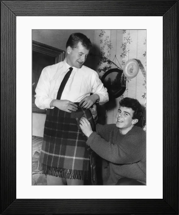 Framed Print : Aston Villa footballer Charlie Aitkens tries out a kilt. 30th December 1961 Framed Print : Aston Villa footballer Charlie Aitkens tries out a kilt. 30th December 1961
