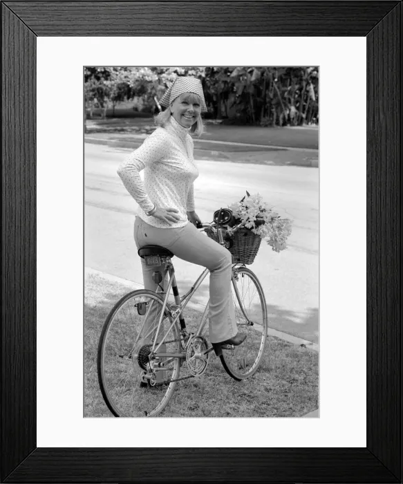 Framed Print : Doris Day seen holding a bunch of flowers on her bicyle Framed Print : Doris Day seen holding a bunch of flowers on her bicyle