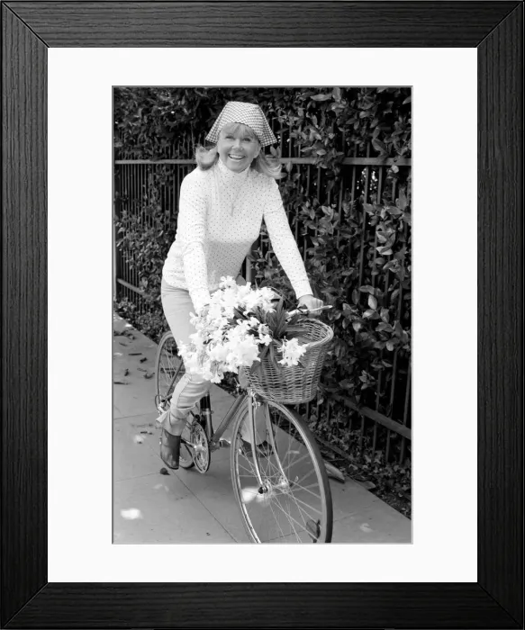 Framed Print : Doris Day seen holding a bunch of flowers on her bicyle Framed Print : Doris Day seen holding a bunch of flowers on her bicyle