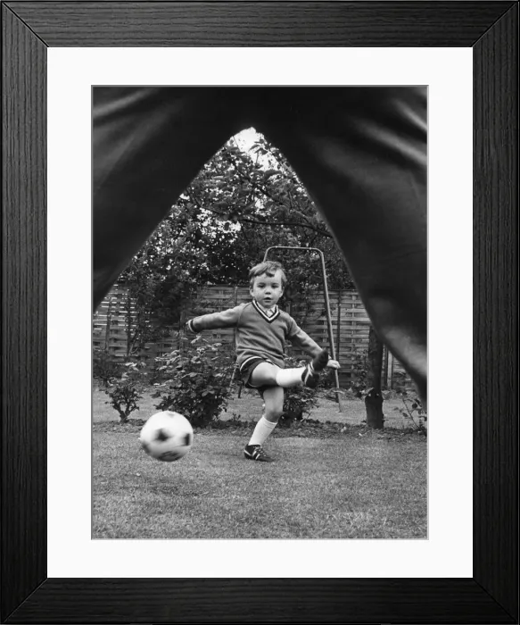 Framed Print : Aston Villa footballer Ron Wylie playing football with his son Nigel in the garden of Framed Print : Aston Villa footballer Ron Wylie playing football with his son Nigel in the garden of