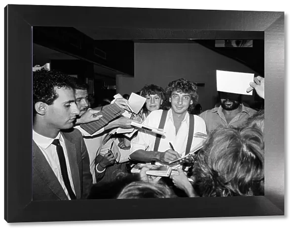 Barry Manilow signs autographs at Capital Radio. 25th August 1983