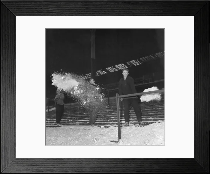 Framed Print : Playing staff help clear terraces of snow, at the Brittania Stadium, home of Stoke City