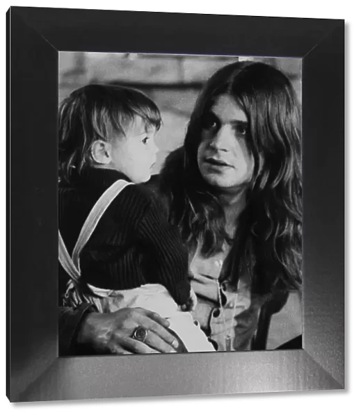 Black Sabbath lead singer Ozzy Osbourne holding his 22 month old daughter Jessica