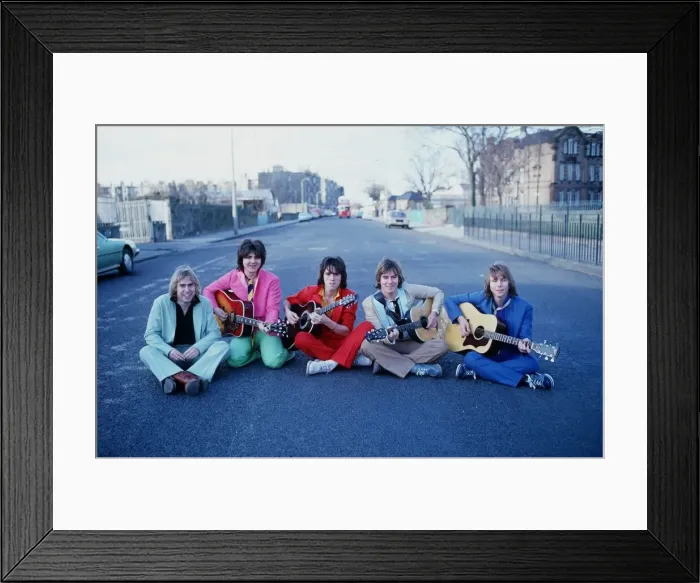 Framed Print : Scottish pop group The Bay City Rollers, sitting in a street holding acoustic guitars Framed Print : Scottish pop group The Bay City Rollers, sitting in a street holding acoustic guitars