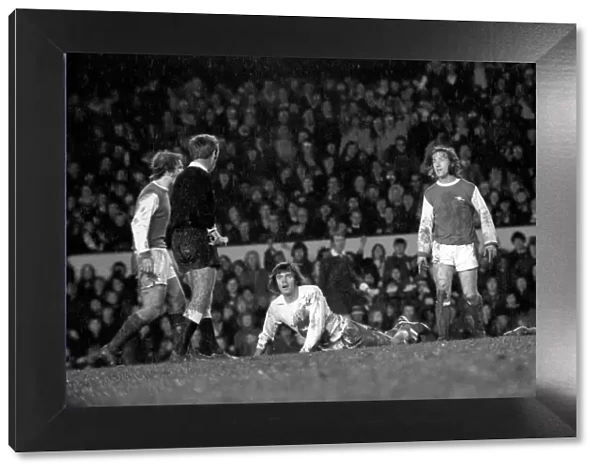 Arsenal vs. Leeds. Peter Lorimer looks at referee Thomas who is about to book him