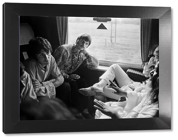 The Beatles with Marhirishi Yogi aboard a train bound for Bangor in North Wales