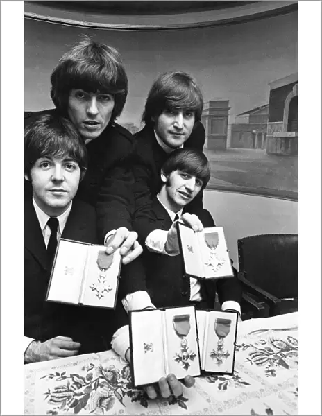 The Beatles show off their MBE medals after the royal investiture at Buckingham Palace