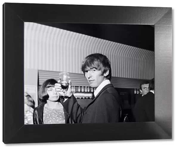 The Beatles George Harrison in the saloon bar of the Prince of Wales Theatre in London