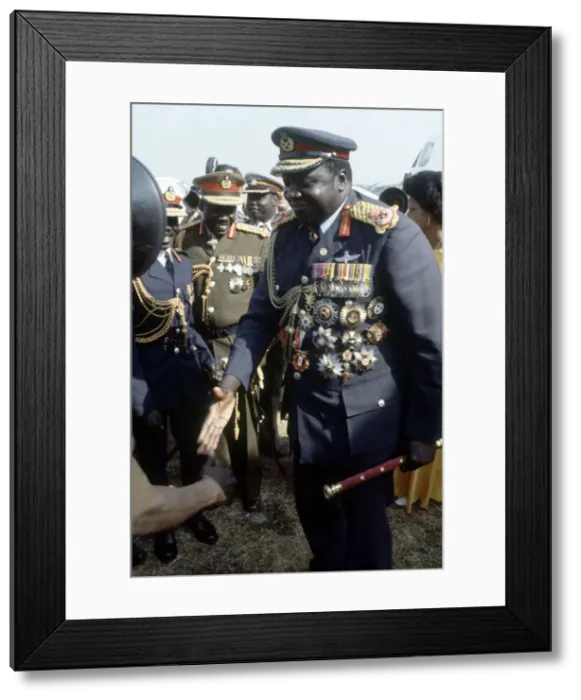 Framed Print : President of Uganda, General Idi Amin, pictured in military uniform greeting people as he Framed Print : President of Uganda, General Idi Amin, pictured in military uniform greeting people as he