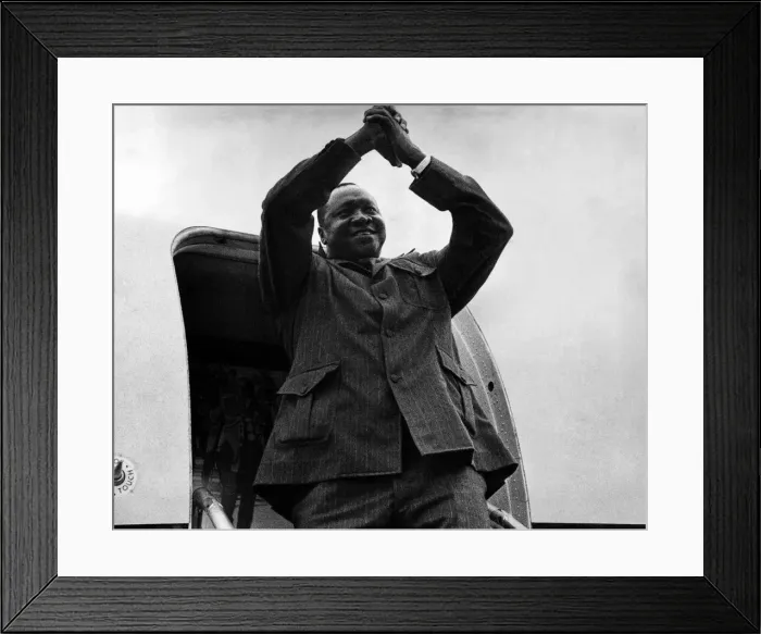 Framed Print : President of Uganda, General Idi Amin, waves goodbye as he boards his plane to return to Framed Print : President of Uganda, General Idi Amin, waves goodbye as he boards his plane to return to