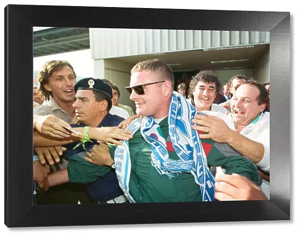 Paul Gascoigne is mobbed by airport workers and Lazio fans on arrival in Rome