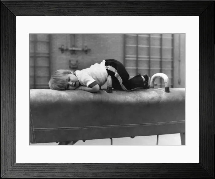 Framed Print : Children: Sports: Taking a break: After a work-out, Sean lies down on a vaulting horse Framed Print : Children: Sports: Taking a break: After a work-out, Sean lies down on a vaulting horse