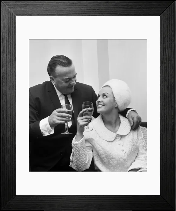 Framed Print : British musician Ronnie Ronalde toasts his new bride Yana after their wedding ceremony Framed Print : British musician Ronnie Ronalde toasts his new bride Yana after their wedding ceremony