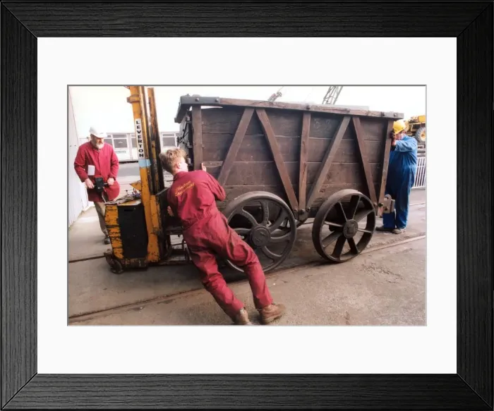 Framed Print : Restoration engineer Grodon Stark, on the flat bed is helping to move an anciet wagon