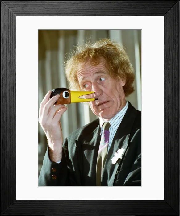 Framed Print : Rod Hull seen here with a miniature head of his feathered partner Emu. 12th January 1993