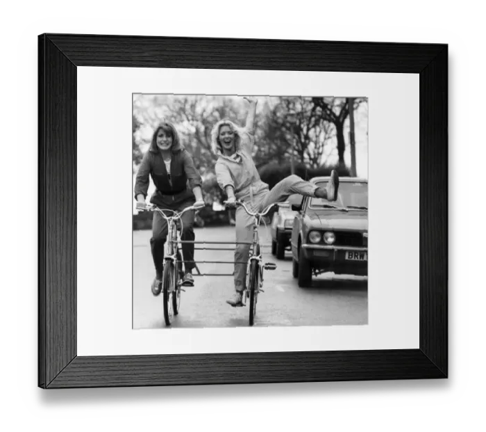 Framed Print : Couple of young ladies on a bicycle made for two, January 1981