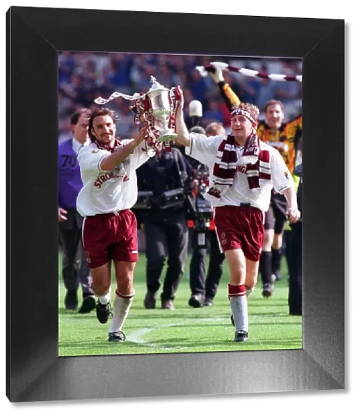 Heart of Midlothian footballer Jim Hamilton carries the Scottish Cup trophy around Celtic