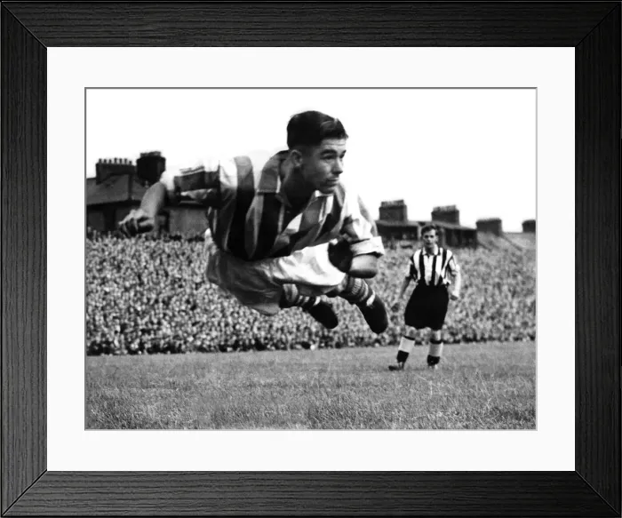 Framed Print : Stoke centre-half Frank Mountford diving to head away a George Robledo shot at Newcastle
