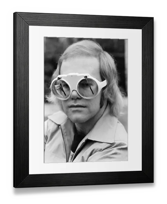 Framed Print : Pop singer Elton John at his home at Virginia Water. His glasses have window screen