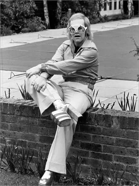 Pop singer Elton John at his home at Virginia Water wearing his latest boots