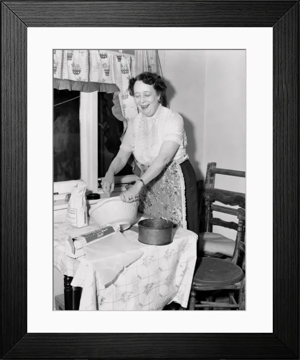 Framed Print : Domestic scenes: A woman making cakes in her kitchen at home. 1954 Framed Print : Domestic scenes: A woman making cakes in her kitchen at home. 1954