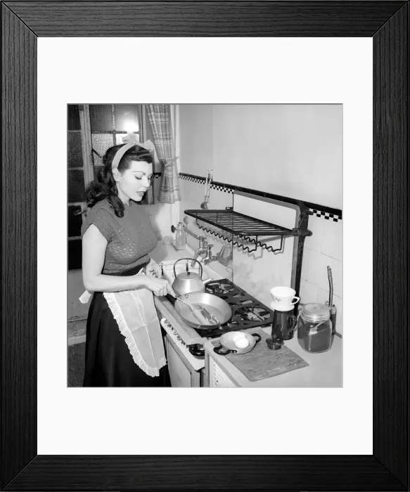 Framed Print : A Housewife cooking in the kitchen, 1957 Framed Print : A Housewife cooking in the kitchen, 1957