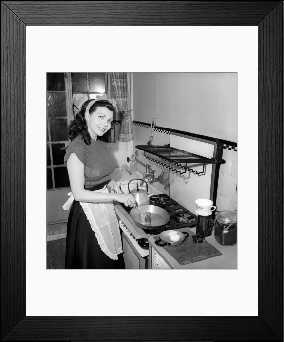 Framed Print : A Housewife cooking in the kitchen, 1957 Framed Print : A Housewife cooking in the kitchen, 1957