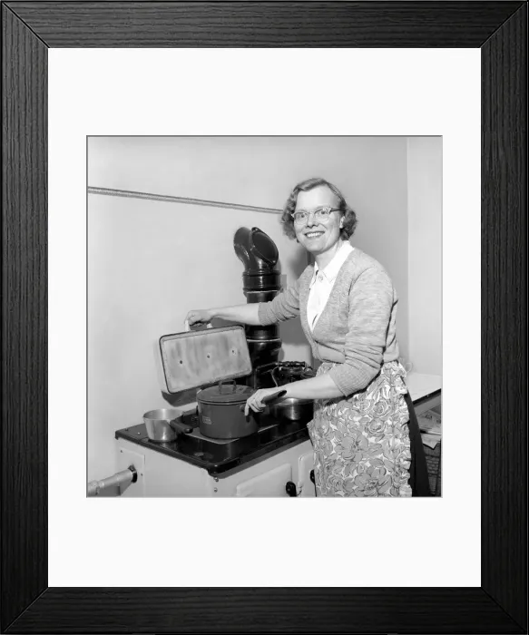 Framed Print : Domestic scenes: A woman cooking in her kitchen at home, 1954 Framed Print : Domestic scenes: A woman cooking in her kitchen at home, 1954
