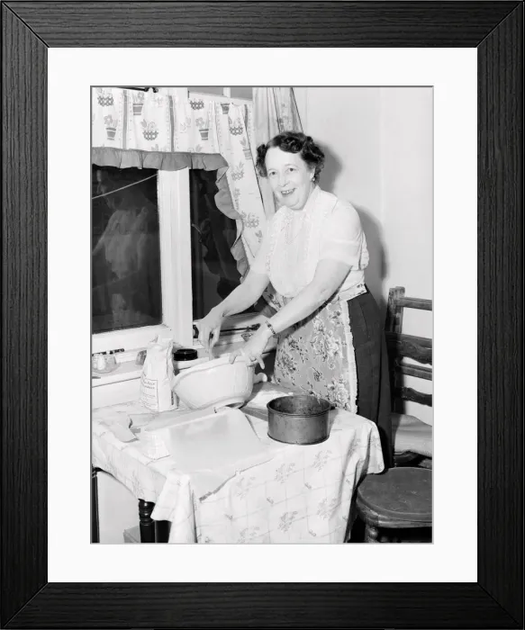 Framed Print : Domestic scenes: A woman making cakes in her kitchen at home. 1954 Framed Print : Domestic scenes: A woman making cakes in her kitchen at home. 1954