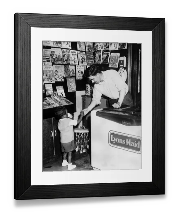 Framed Print : Jackie Blanchflower of Manchester United serves an ice cream to a young boy in his newly