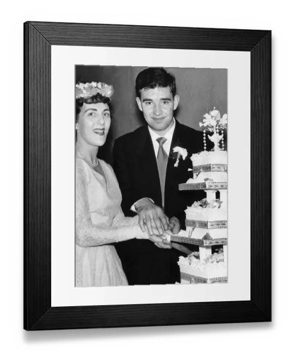 Framed Print : Manchester United footballer Jackie Blanchflower cuts the wedding cake on his wedding day