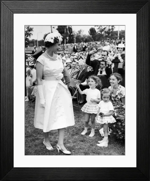 Framed Print : Royal Tour of Canada. The Queen receives a flower from a young girl after she had Framed Print : Royal Tour of Canada. The Queen receives a flower from a young girl after she had