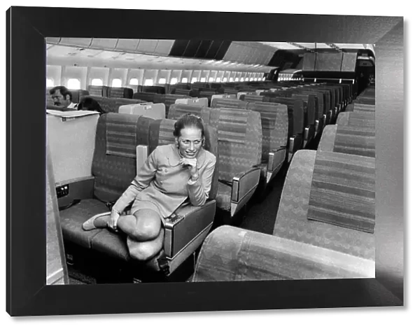 Stewardess Jane Ridley sits in the huge cabin of a Lockheed Tri-Star airliner named