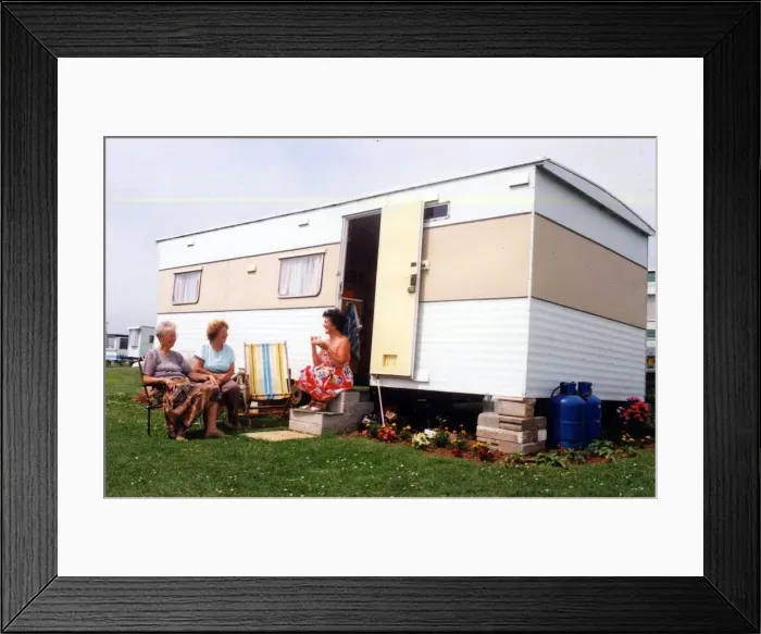 Framed Print : Caravans - Holidaymakers enjoying the sunshine, outside their caravan