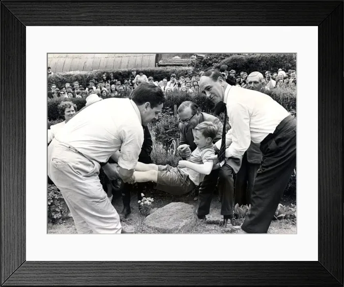 Framed Print : Beating the bounds - Llantrisant - Townspeople watch as seven-year-old Kevin Davies is Framed Print : Beating the bounds - Llantrisant - Townspeople watch as seven-year-old Kevin Davies is