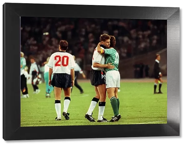 Chris Waddle Football is consoled and embraced by Lothar Matthaus of W Germany after
